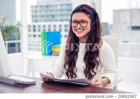 Smiling Asian woman holding documents 20682907