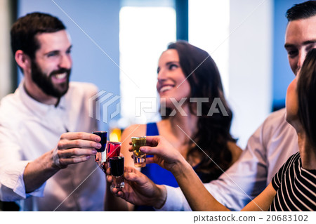 Friends toasting with alcohol shots 20683102