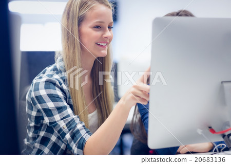 Smiling students using computer Smiling students using computer 20683136