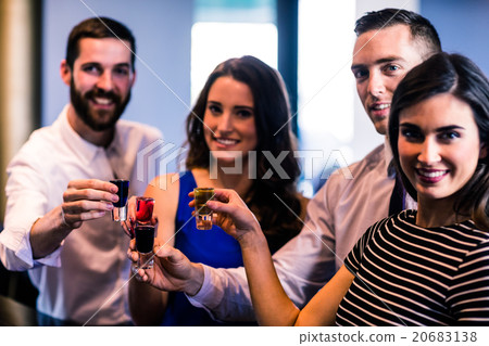 Friends toasting with alcohol shots Friends toasting with alcohol shots 20683138