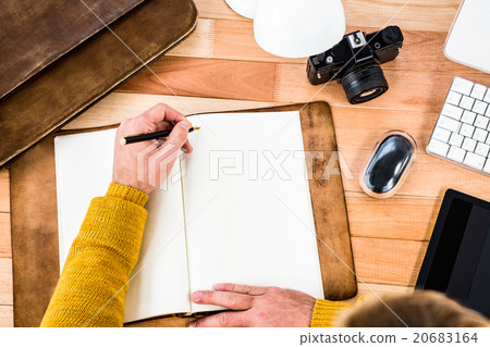 Above view of man writing on notebook Above view of man writing on notebook 20683164