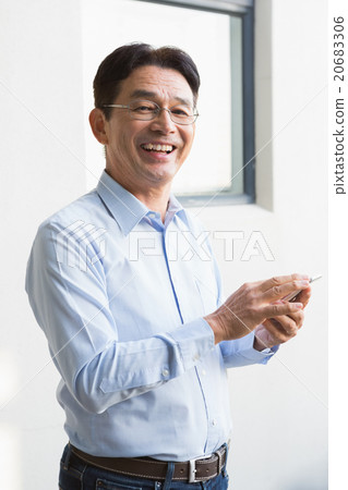 Smiling man using smartphone Smiling man using smartphone 20683306
