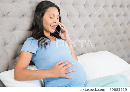 Pregnant brunette on phone call Pregnant brunette on phone call 20683319