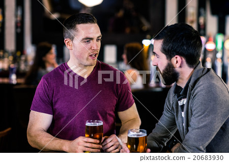 Friends talking and having a pint Friends talking and having a pint 20683930