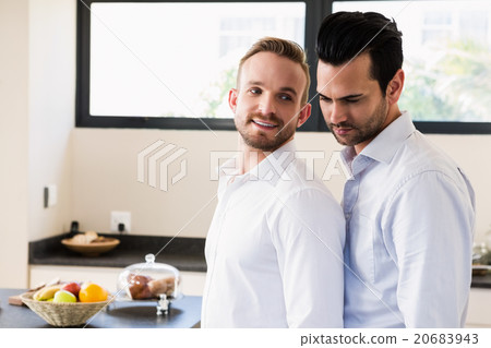 Smiling gay couple in the kitchen 20683943