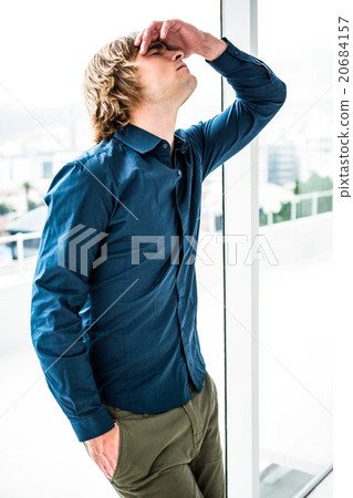 Troubled hipster businessman holding his head Troubled hipster businessman holding his head 20684157