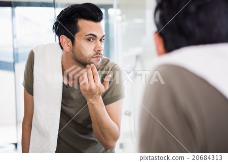 Handsome man looking in mirror Handsome man looking in mirror 20684313