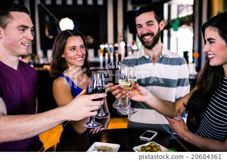 Group of friends having a glass of wine Group of friends having a glass of wine 20684361