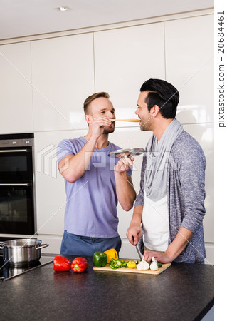 Smiling man tasting soup 20684461