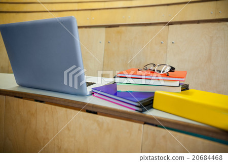 Students books and laptop in an auditorium 20684468