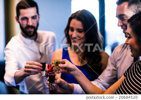 Friends toasting with alcohol shots Friends toasting with alcohol shots 20684520