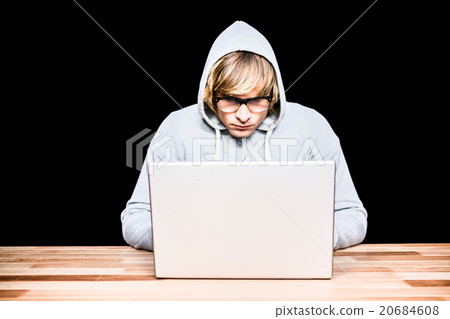 Man in hood jacket hacking a laptop 20684608