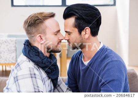 Gay couple about to kiss on the couch Gay couple about to kiss on the couch 20684617