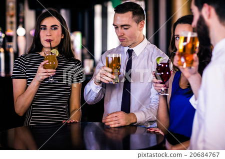 Friends drinking cocktails and beers Friends drinking cocktails and beers 20684767