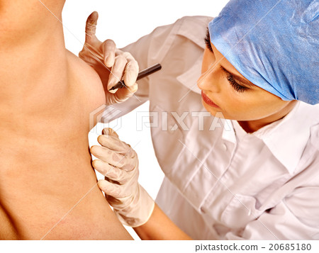 Doctor makes dotted line on female breast . 20685180