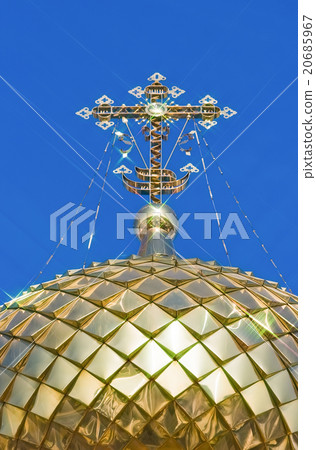Golden orthodox cross against blue sky background Golden orthodox cross against blue sky background 20685967