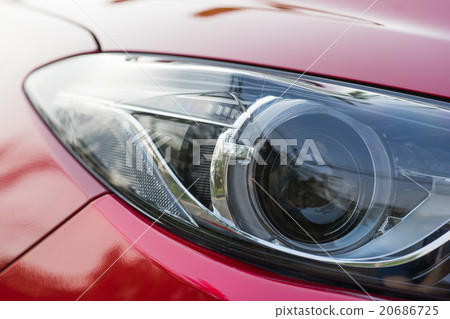 Xenon projector headlight of a red car Xenon projector headlight of a red car 20686725