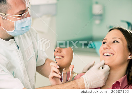 Satisfied smiling patient with dentist 20687193