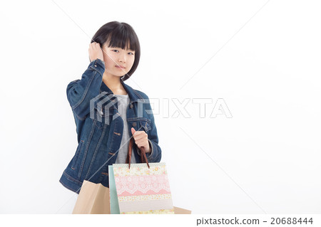 A girl who seems to be happy shopping a lot 20688444
