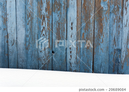 Blue wooden fence in snow. 20689084