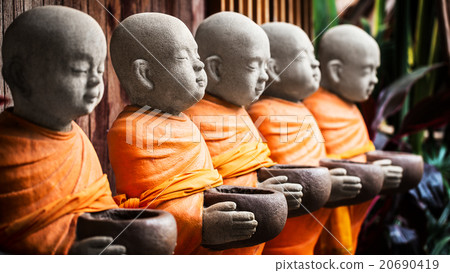 Monk statue holding bowl 20690419