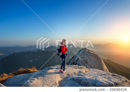 Woman stands on the peak of stone in Bukhansan. Woman stands on the peak of stone in Bukhansan. 20696426