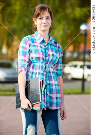 Portrait of young alluring woman holding education Portrait of young alluring woman holding education 20699482