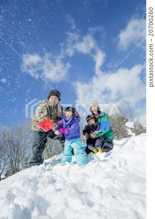 4 people family playing with snow on the snow hill 4 people family playing with snow on the snow hill 20700260
