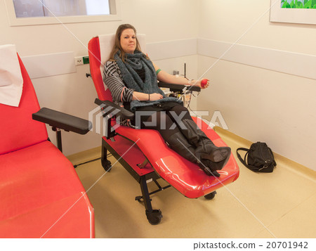 Donor in an armchair donates blood 20701942