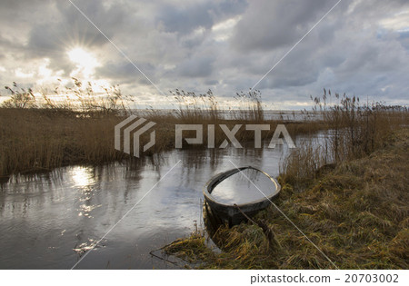 river mouth with sank boat at sunset river mouth with sank boat at sunset 20703002