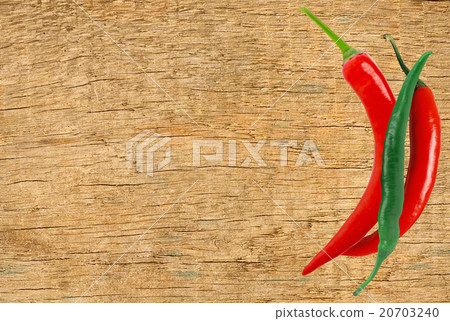 Red and green hot peppers on wooden table close up Red and green hot peppers on wooden table close up 20703240