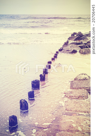 Retro old film stylized photo of a breakwater. 20706445
