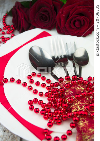 Table setting with red roses on white wood  20706535