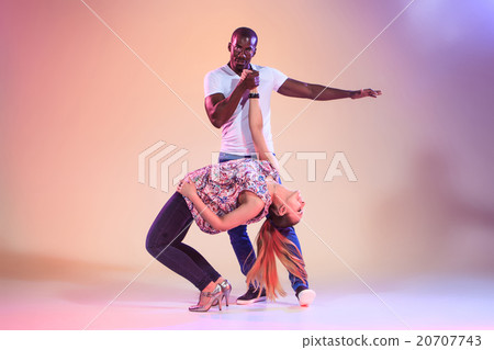 Young couple dances social Caribbean Salsa, studio Young couple dances social Caribbean Salsa, studio 20707743