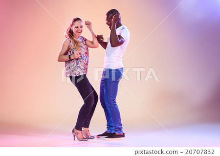 Young couple dances social Caribbean Salsa, studio 20707832