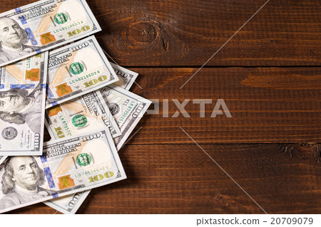 new 100 US dollars bills on wooden background 20709079