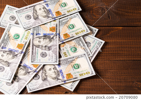 new 100 US dollars bills on wooden background new 100 US dollars bills on wooden background 20709080