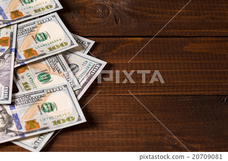 new 100 US dollars bills on wooden background 20709081