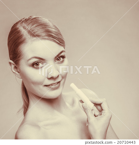 Young woman take balm on lips. Young woman take balm on lips. 20710443