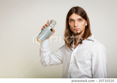 Young man with shaker making cocktail drink 20710520