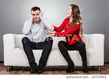 Wife shouting at husband. Cheating man. Betrayal. Wife shouting at husband. Cheating man. Betrayal. 20710985
