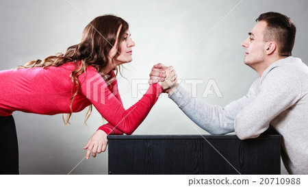Arm wrestling challenge between young couple Arm wrestling challenge between young couple 20710988