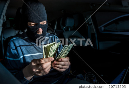 Hacker with a laptop inside a car Hacker with a laptop inside a car 20713203