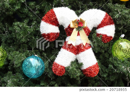 Christmas decorations hanging on christmas tree. Christmas decorations hanging on christmas tree. 20718935