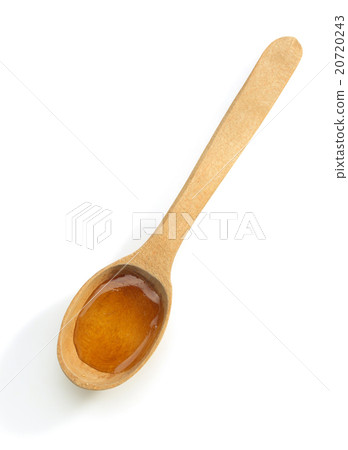 wooden spoon and honey on white 20720243