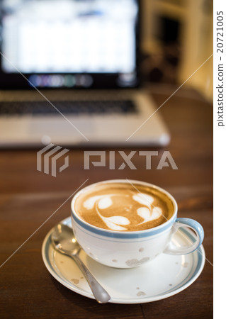 Coffee cup and laptop on table background Coffee cup and laptop on table background 20721005