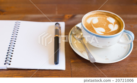 Coffee cup and notebook on table background 20721006