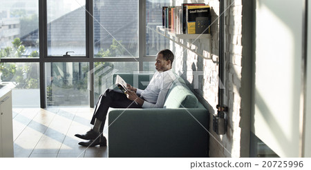 Businessman Reading Magazine Relaxation Concept 20725996