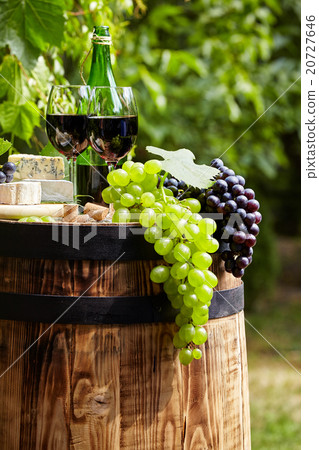 Bottle of white wine with wineglass and grapes  20727646