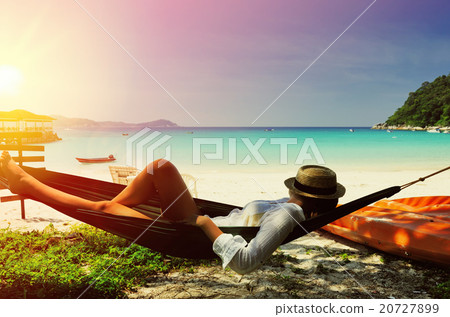 Woman in hammock on beach 20727899
